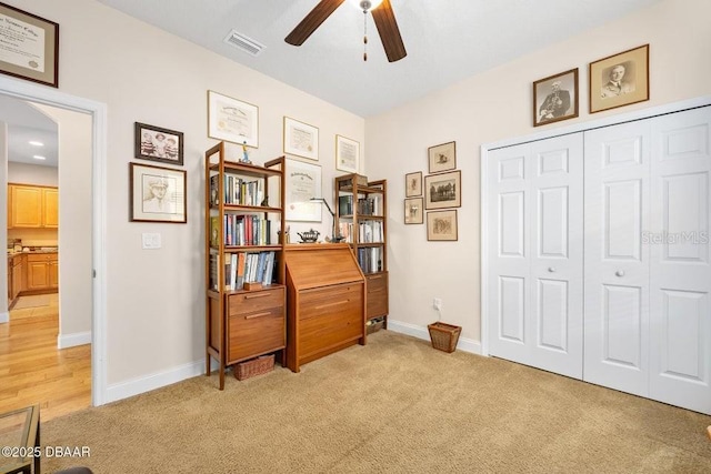 miscellaneous room featuring ceiling fan and light carpet