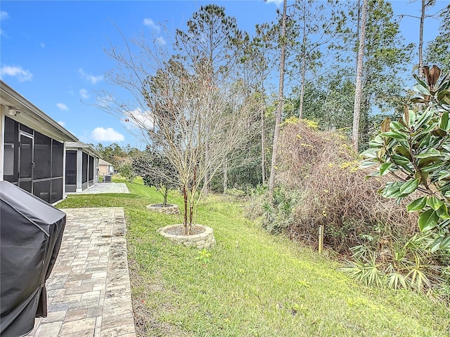 view of yard with a patio area and a sunroom