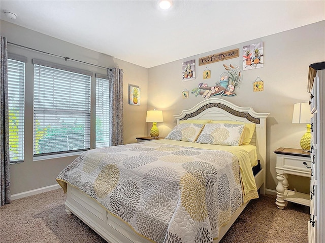 carpeted bedroom featuring multiple windows