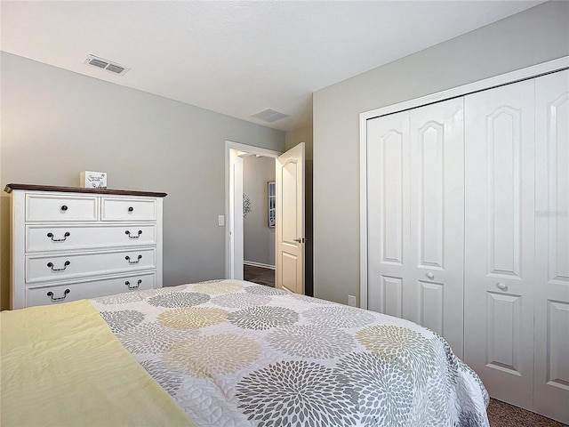 bedroom with a closet and dark colored carpet