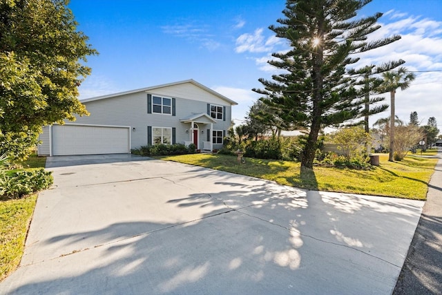 view of front of home with a front lawn and a garage