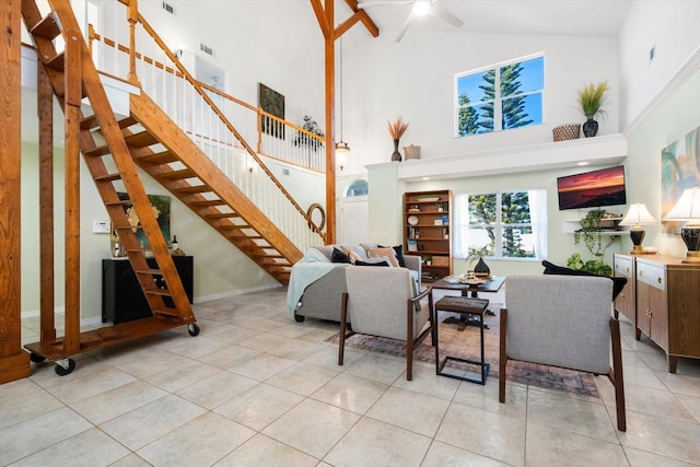 tiled living room featuring ceiling fan and high vaulted ceiling