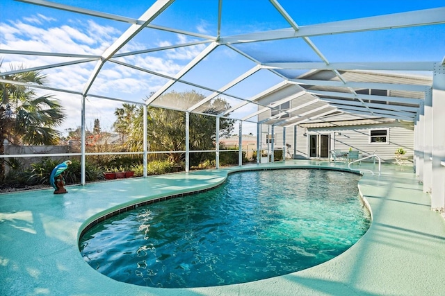 view of pool featuring glass enclosure and a patio