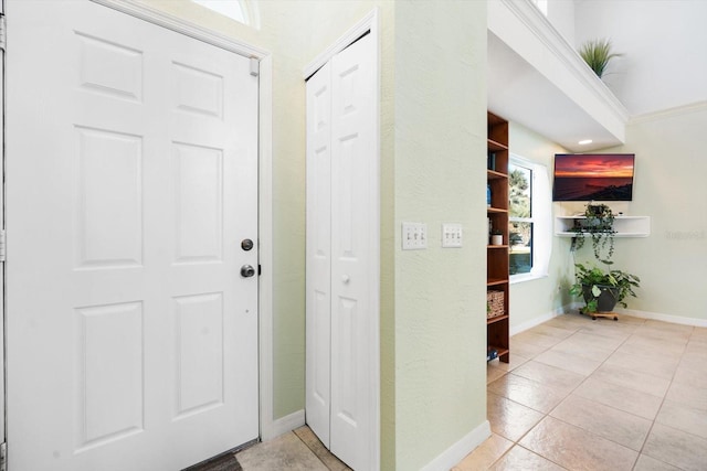 tiled entryway with ornamental molding