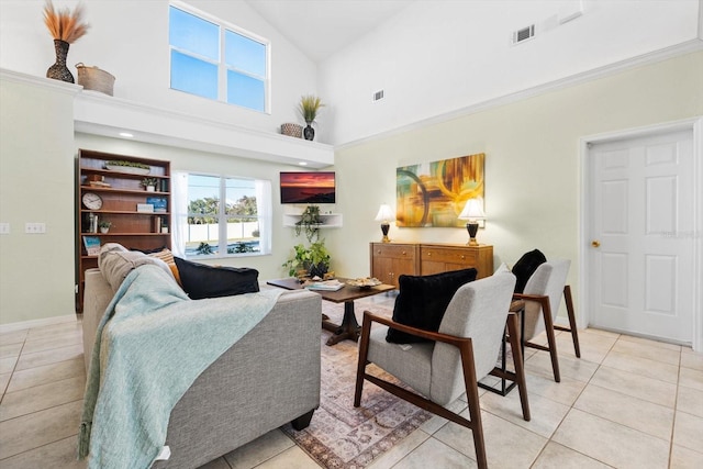 living room with high vaulted ceiling and light tile patterned floors