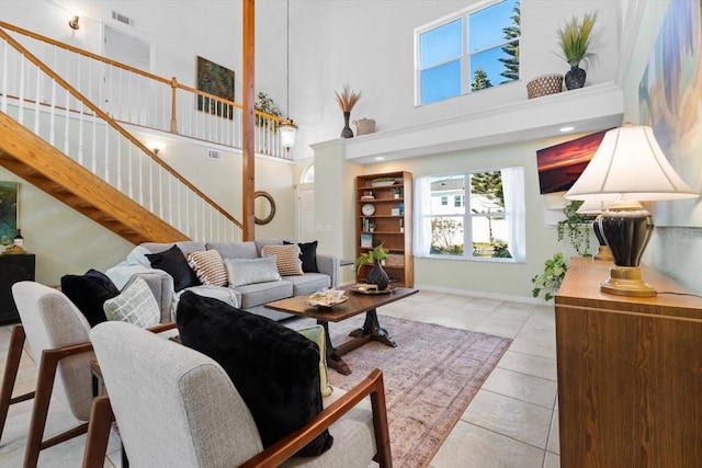 living room featuring light tile patterned flooring and a high ceiling