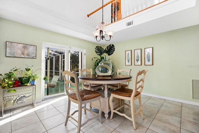 tiled dining room with a chandelier