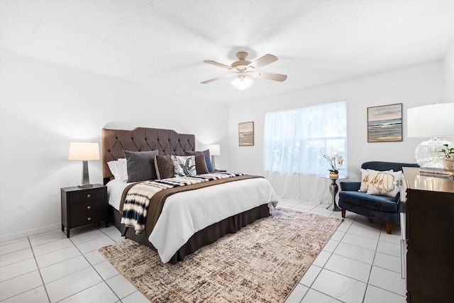 tiled bedroom featuring ceiling fan