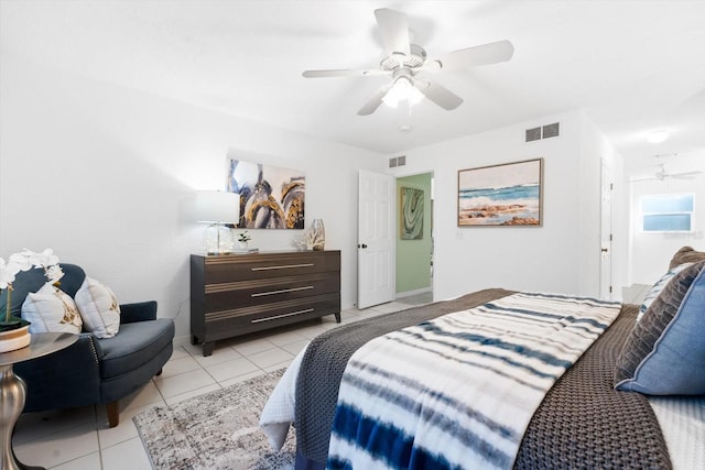 bedroom with ceiling fan and light tile patterned flooring