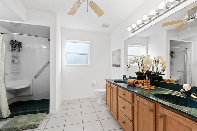 bathroom with toilet, a shower with shower curtain, and a healthy amount of sunlight