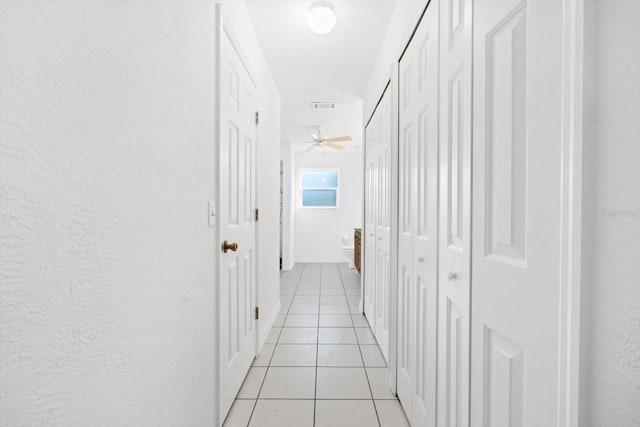 corridor with light tile patterned floors