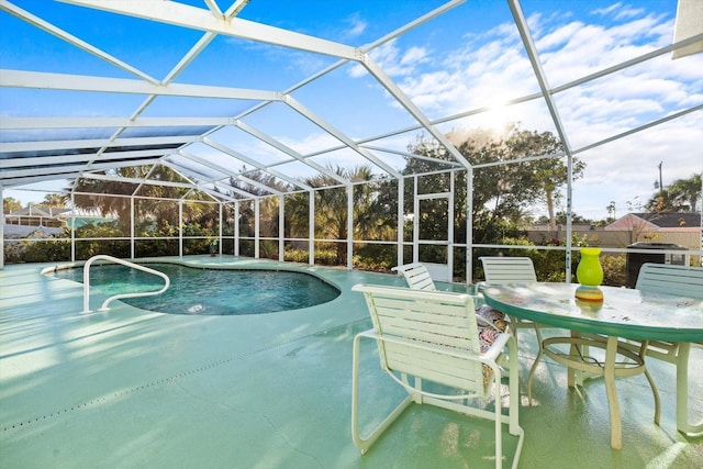 view of pool with a patio and glass enclosure