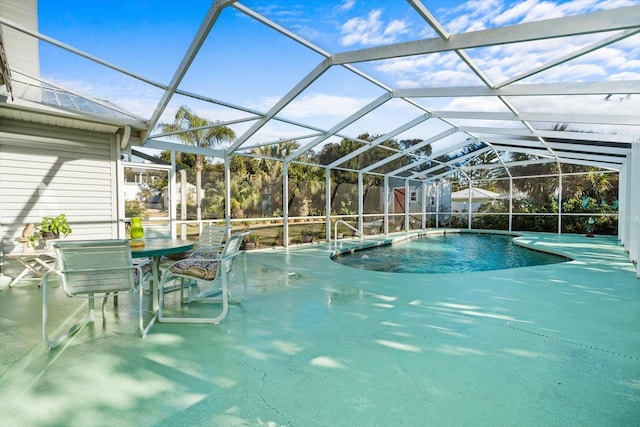 view of swimming pool with a lanai and a patio