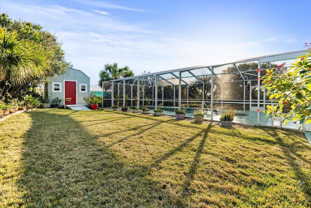 view of yard with a lanai and a storage shed