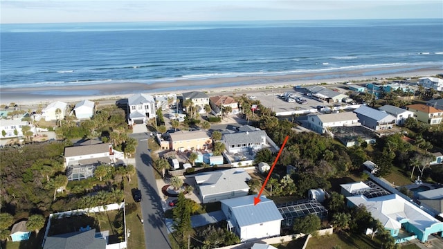 bird's eye view featuring a water view and a beach view