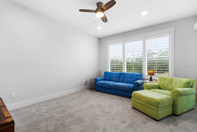 living room with light carpet and ceiling fan