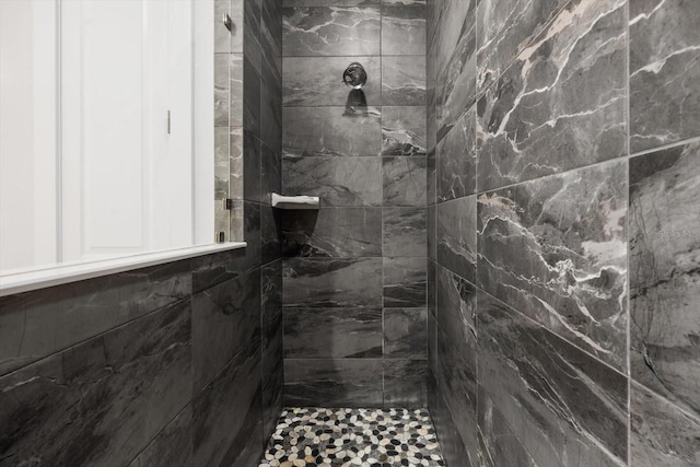 bathroom with a tile shower