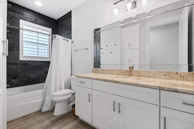 full bathroom featuring hardwood / wood-style flooring, vanity, toilet, and shower / tub combo with curtain