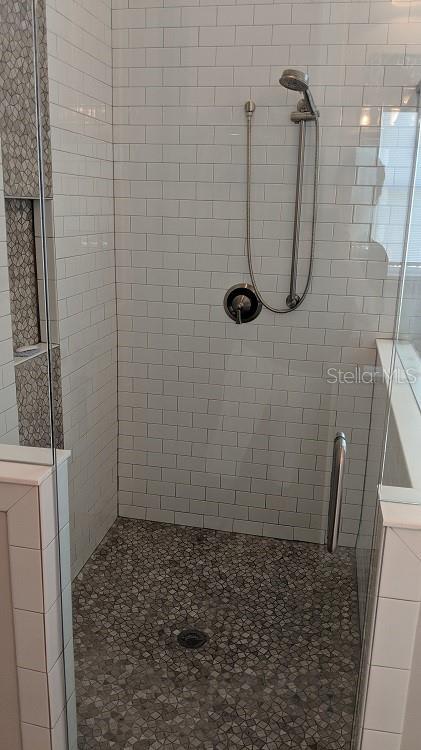 bathroom with a shower with shower door