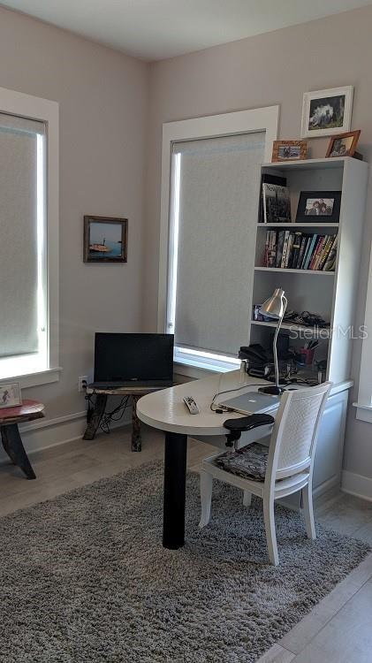 home office with hardwood / wood-style flooring