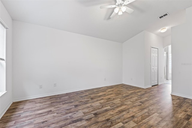 empty room featuring ceiling fan and dark hardwood / wood-style flooring