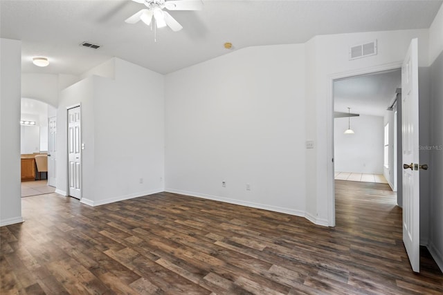 unfurnished room featuring vaulted ceiling, ceiling fan, and dark hardwood / wood-style flooring