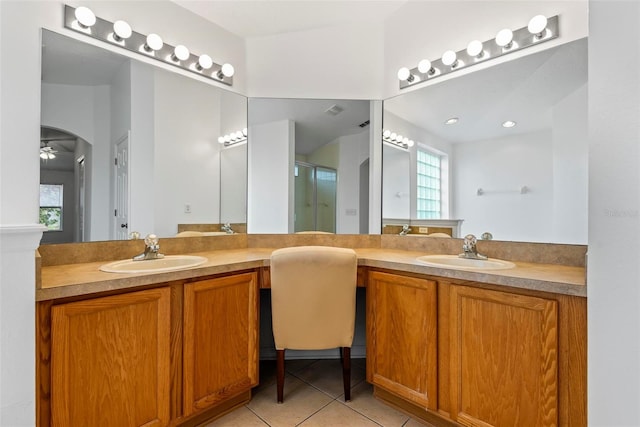 bathroom featuring vanity, tile patterned floors, and walk in shower