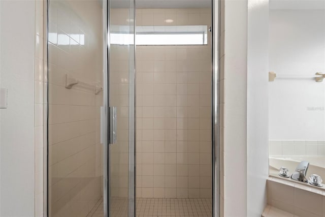 bathroom featuring shower with separate bathtub