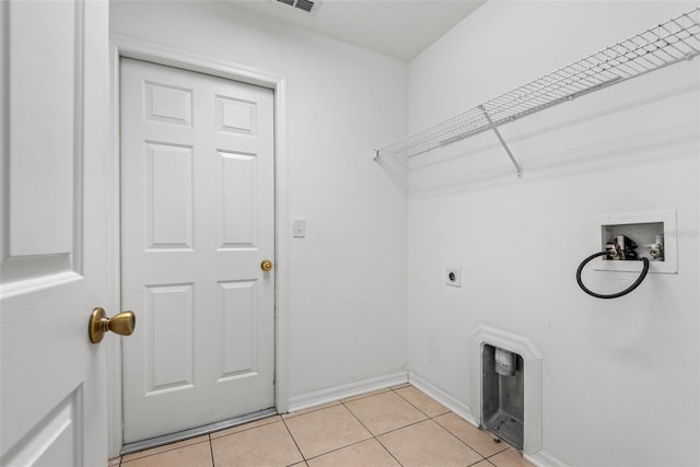 clothes washing area with washer hookup, hookup for an electric dryer, and light tile patterned floors