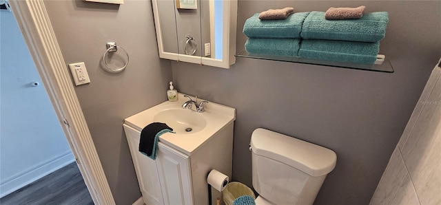 bathroom featuring toilet and vanity