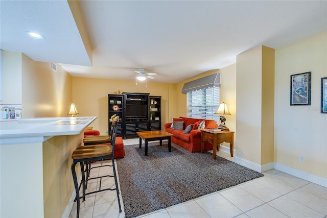 living room featuring light tile patterned flooring and ceiling fan