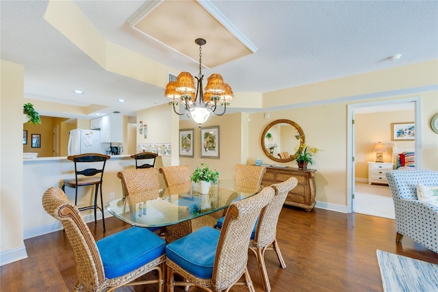 dining space featuring an inviting chandelier and dark wood-type flooring