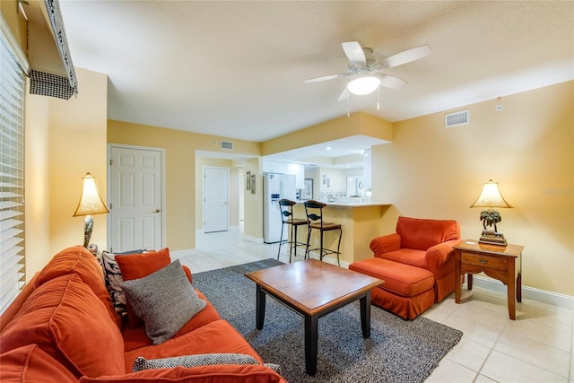 tiled living room featuring ceiling fan