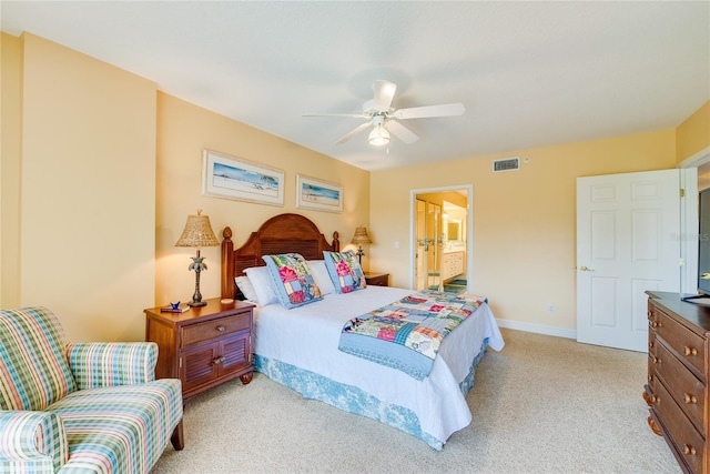 bedroom featuring ensuite bath, ceiling fan, and light colored carpet