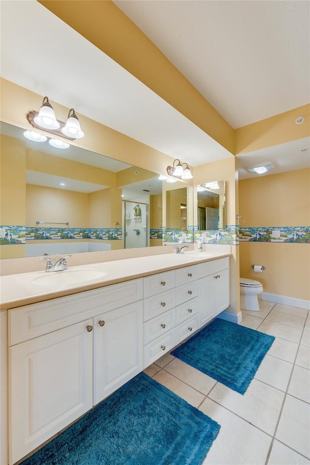 bathroom with toilet, tile patterned flooring, and vanity