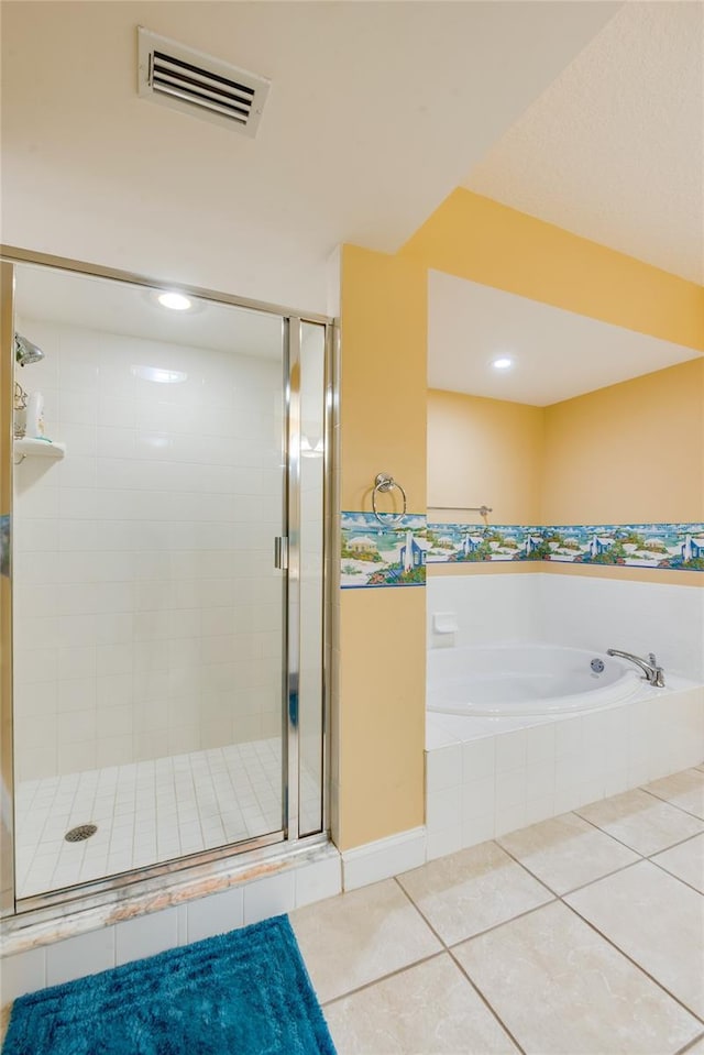 bathroom with tile patterned flooring and independent shower and bath