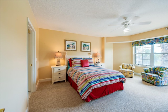 bedroom with a textured ceiling, ceiling fan, and carpet flooring