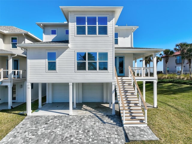 view of front of house featuring a garage, a front yard, and covered porch