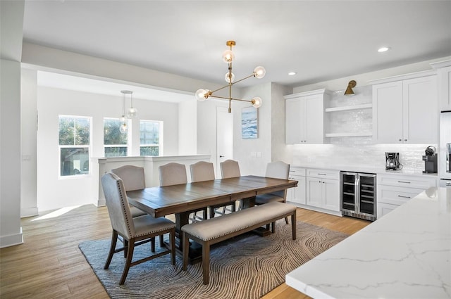 dining room with beverage cooler and light wood-type flooring