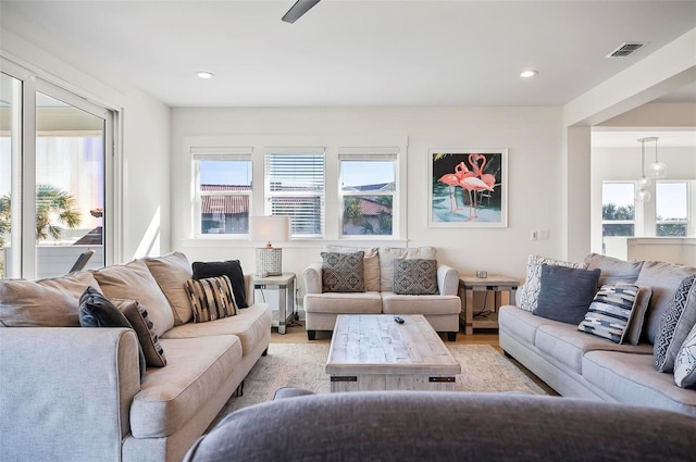 living room with plenty of natural light and light hardwood / wood-style flooring