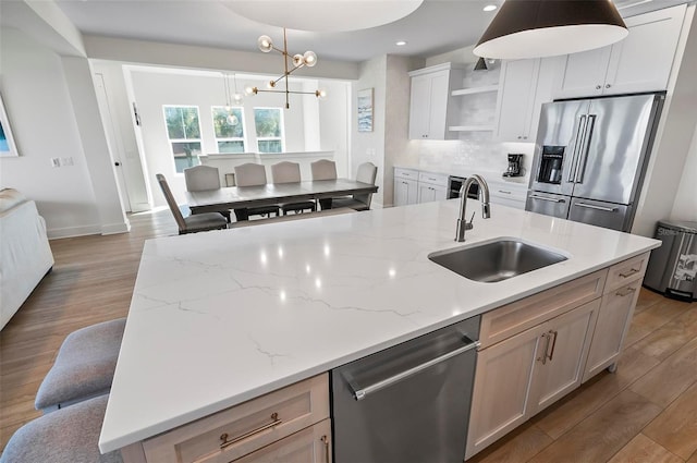 kitchen featuring white cabinetry, sink, and appliances with stainless steel finishes