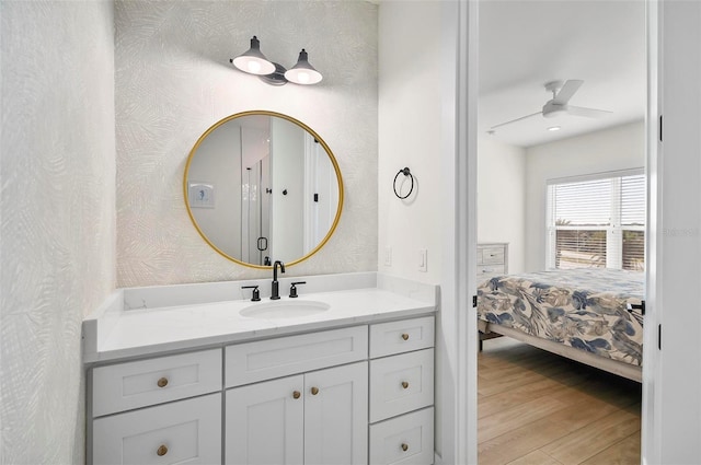 bathroom featuring vanity, hardwood / wood-style floors, and ceiling fan