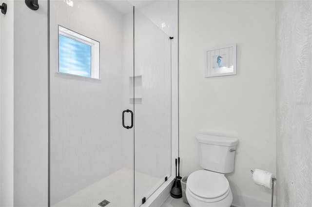 bathroom featuring walk in shower and toilet