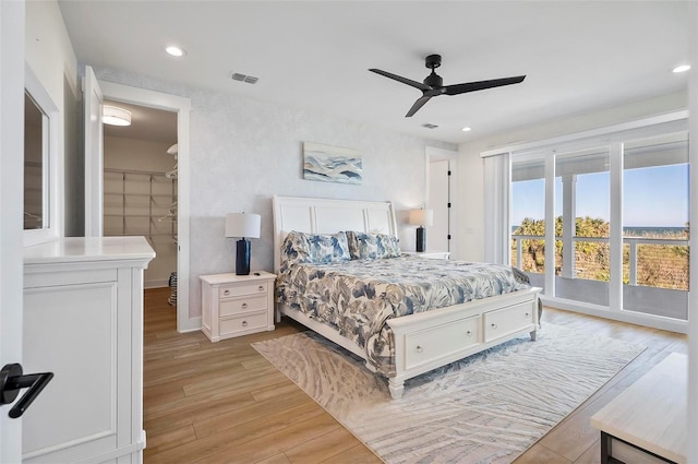 bedroom with access to exterior, ceiling fan, and light hardwood / wood-style flooring