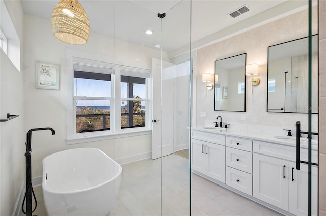 bathroom with vanity and a tub