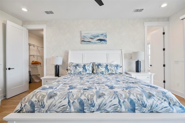 bedroom with ceiling fan and light hardwood / wood-style floors