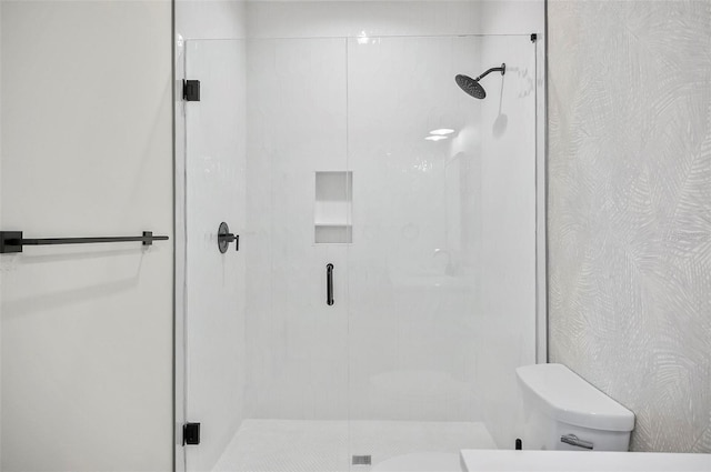 bathroom featuring toilet and walk in shower