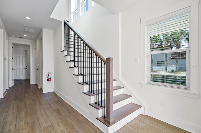 stairway featuring wood-type flooring