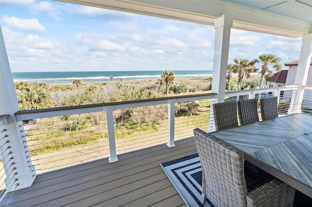 balcony featuring a beach view and a water view