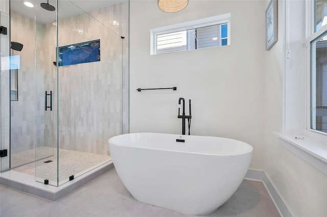 bathroom featuring tile patterned flooring and independent shower and bath